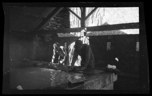 Warren Favor and possibly Leland Waite, of the U. S. Army's 649th Engineer Battalion doing laundry in a wash-house, Algeria