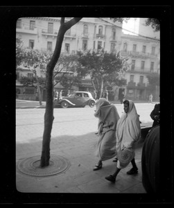 Two women walking on a city street, likely Algiers
