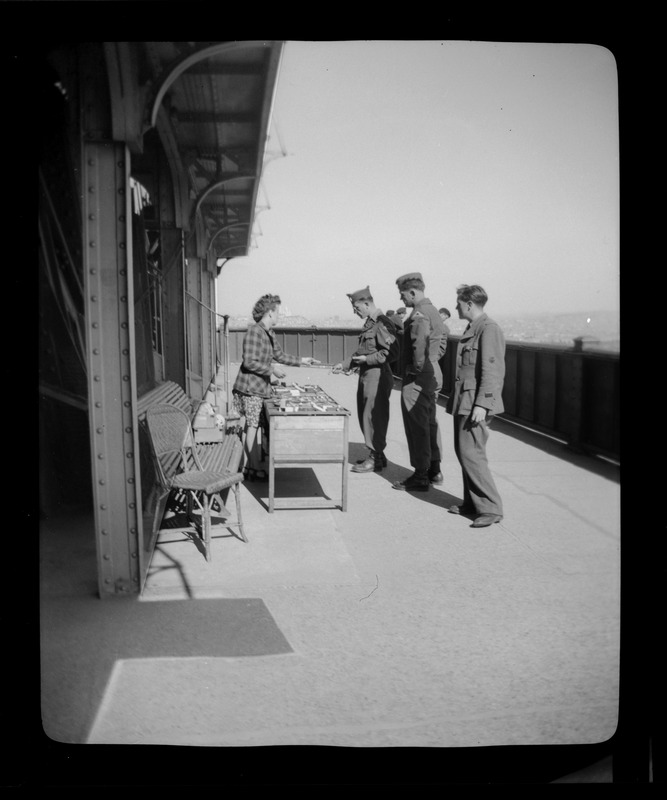 U. S. Army soldiers at souvenir table, Eiffel Tower, Paris