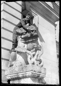 Warren Favor, of the U. S. Army's 649th Engineer Battalion, posing with stone lion, Palace of Fontainebleau, France