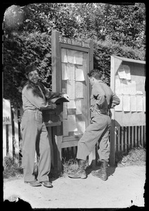 U. S. Army soldiers, including Joseph Warnick, left, of the 649th Engineer Battalion, at bulletin board, Waiblingen, Germany