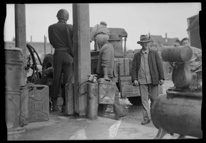 Men loading truck with gas cans, Waiblingen, Germany