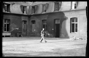U. S. Army soldier walking across courtyard, Fontainebleau, France
