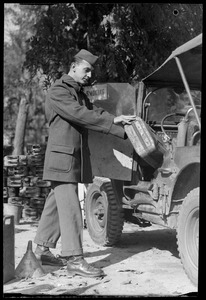 U. S. Army soldier from the 649th Engineer Battalion gassing a jeep, Fontainebleau, France