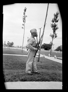 U. S. Army soldier in gas mask with rifle, Fort Belvoir