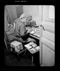 Henry L. Buffaloe, of the U. S. Army's 649th Engineering Battalion, sorting film prints, Fontainebleau, France