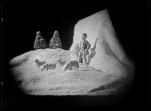 Diorama of mountain scene with shepherd and sheep figurines