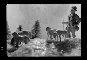 Diorama of mountain scene with shepherd and sheep figurines