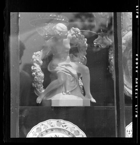 Figurine of woman with rose garland, in glass case