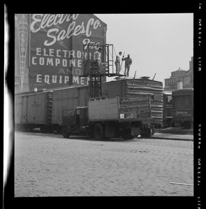 Men loading ice into boxcar, Quincy Market Cold Storage, Sargent's Wharf, Boston