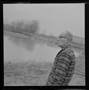 Albert Elwell looking out at a field at Maple Crest Farm