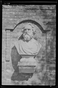 A bust of the poet graces the brick garden wall, Wayside Inn, Sudbury