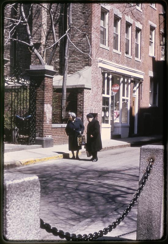 Two women standing at the entrance to the courtyard of the Old North Church