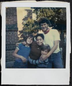 Young man posing with three children
