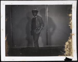 Boy posing with a baseball cap and jacket