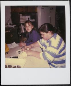 Two girls sitting at a table