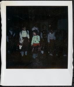 Children dancing in plaid skirts