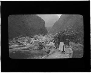 Men and horse crossing river