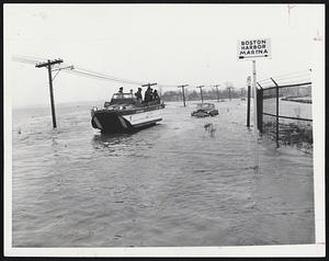 The Marina Sign should point downward instead of to the right, photo left as an amphibious vehicle owned by the City of Quincy moves down Squantum causeway. At right, Torpedoman Robert
