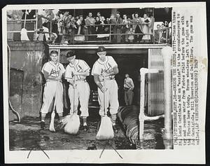 Sweeps The Series,?????--These three St. Louis Cardinals add an "assist" to the groundskeepers to try and remove water form Forbes Field before the game with the Pirates here today. Broom wheelers left to right are Joe Garagiola, Bill Howerton and Del Wilbur. The game was called.