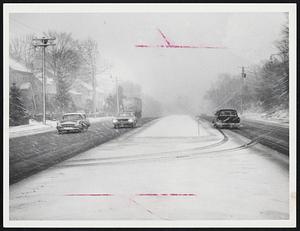 Sudden Snowstorm - Route 2 (Concord Turnpike) in Arlington a few minutes after blinding snow hit the area yesterday afternoon. Visibility was cut to near zero, and many motorists pulled over to the roadside to await passing of the squall. Note the headlights, at 3:30 p.m., of car in center.