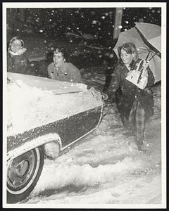 Ellen Horey, Eileen Costello and Ellen McCarthy all of J.P. push a friend's car on Center St hill Jamaica Plain