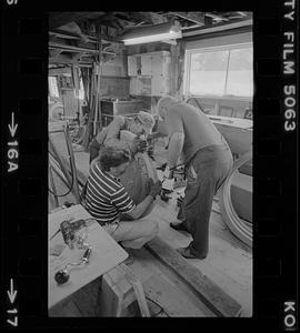 Men working in Pert Lowell's boat shop