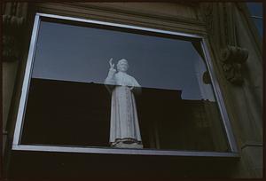 Statue of priest behind a window, Boston