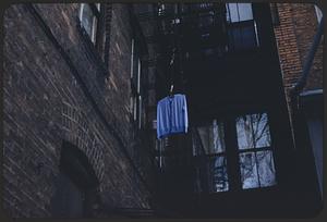 Sweater hanging off fire escape