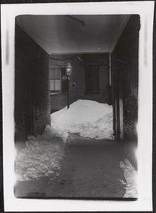 View of snow pile and street lamp, North End, Boston