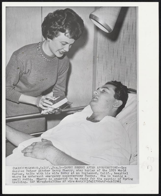 Larry Sherry After Appendectomy--Los Angeles Dodger pitcher Larry Sherry, star hurler of the 1959 World Series, talks with his wife today at an Inglewood, Calif., hospital where he underwent emergency appendectomy Sunday. She is tuning a small radio. Sherry is expected to be ready for the opening of Spring training.