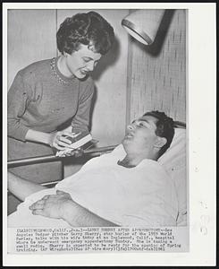 Larry Sherry After Appendectomy--Los Angeles Dodger pitcher Larry Sherry, star hurler of the 1959 World Series, talks with his wife today at an Inglewood, Calif., hospital where he underwent emergency appendectomy Sunday. She is tuning a small radio. Sherry is expected to be ready for the opening of Spring training.