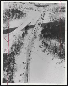 Snow Stalls The Whole Line - This view of Rte. 128 in Needham shows the tangle of cars and big trailer trucks just before the digging out started yesterday morning.