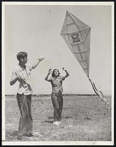 Brother-Sister Win Kite Contest. Fifteen year old Ed Bernadou and his sister Helen, 17, won first prize for best workmanship in the Kite Contest which attracted about 80 entries of all shapes and sizes.