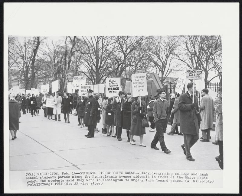 Students Picket White House--Placard-carrying college and high school students parade along the Pennsylvania Avenue sidewalk in front of the White House today. The students said they were in Washington to urge a turn toward peace.