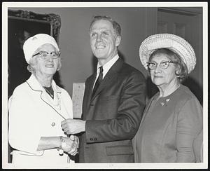 Mayor White receives invitation to attend the 41st annual meeting of the 5,000 member auxiliary of New England Sinai Hospital, from Mrs. Rose B. Pfau, president of the auxiliary's board of governors, and chairman Mrs. Eva Borenstein, right, both of Brookline. Meeting will be May 13 at the Statler Hilton Hotel.