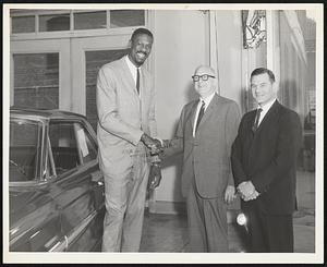 Left to Right: Bill Russell, Salesman; Abe Maltz, president: and Sid Braveman, sales manager, of Eliot Ford, Roxbury.