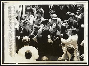 Blood in Financial District--Ted Kavanau, news director of WNEW Television News, is restrained after being injured in melee between peace demonstrators and workers near the New York Stock Exchange at Broad and Wall Streets Friday. At least ten people were admitted to a nearby hospital.