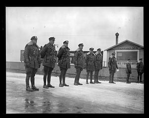 State troopers stand in a row on a snowy road