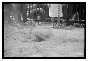 Two young women playing horseshoes