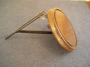 Round wooden shelf attached to a bracket
