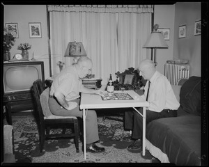 Victor G. Montairs playing checkers [with Leon Abdalian]