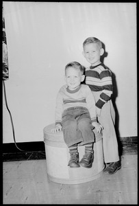 Two boys, one seated