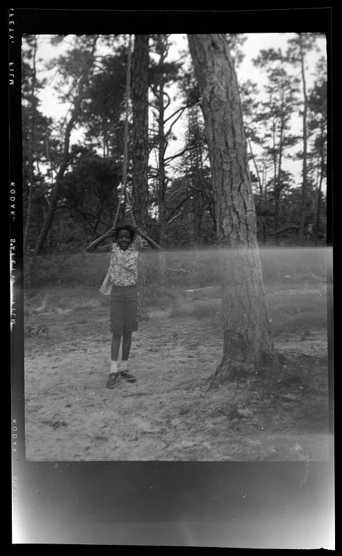 Child stands in a rope swing