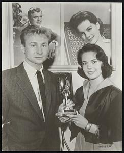 Nick Adams shows his friend Natalie Wood the "Pierre" Statuette awarded him by the Universal Fan Clubs Association for his popularity with the fans and his outstanding work in recent pictures including his latest for Warner Bros.', No Time For Sergeants. The Pierre, the Fan Club's "Oscar," was also awarded to Marlon Brando, Rock Hudson and Esther Williams, and a posthumous award to James Dean. Natalie Wood will be next to be see in Warner Bros.' No Sleep Till Dawn and Marjorie Morningstar.