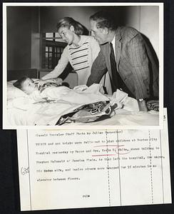 Treats and not tricks were delivered to sick children at Boston City Hospital yesterday by Mayor and Mrs. Kevin H. White, shown talking to Stephen McDonald of Jamaica Plain. As they left the hospital, the mayor, his wife, and twelve others were trapped for 15 minutes in an elevator between floors.