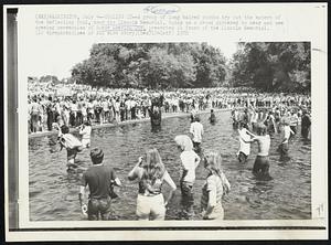 Cooling It-- A group of long haired youths try out the waters of the Reflecting Pool, near the Lincoln Memorial today as a crowd gathered to hear and see opening ceremonies of Honor America Day, presented in front of the Lincoln Memorial.