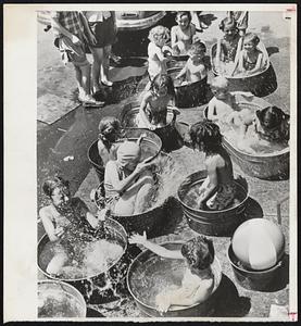 One Way to Beat the Heat-No matter how hot it gets these youngsters in Chicago's westside don't mind it. Their enterprising mothers set out large wash tubs filled with cool water and happy youngsters splash away to their hearts' content.