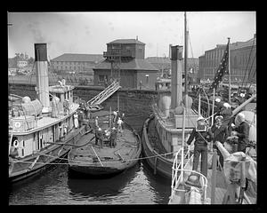 Tug "Iwana" next to other boats and ships, Navy Yard
