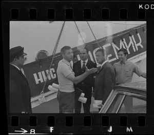 Unidentified men next to Russian oceanographic research ship Akademik Kurchatov, docked at Commonwealth Pier